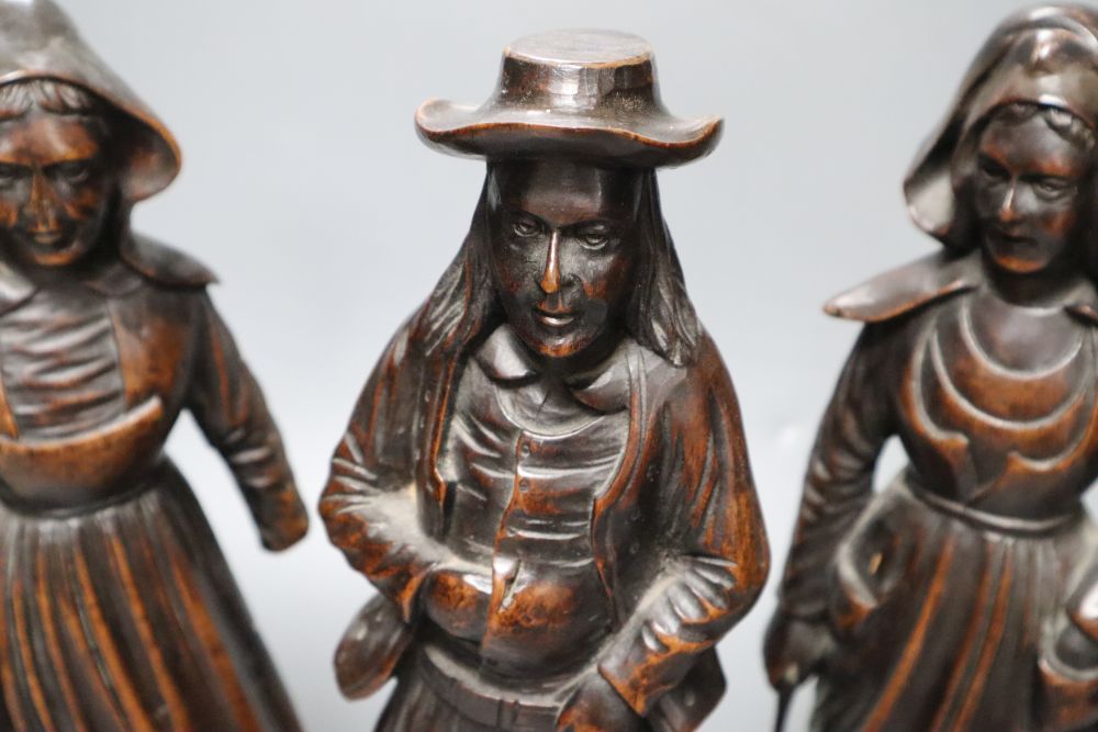 A set of three 19th century Dutch walnut figures of puritans, height 34cm